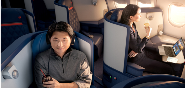 Flight Attendant serving a customer sitting in Delta One